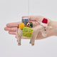 Handmade felt Donkey with Gifts ornament from Craftspring held in front of a hand to show its size—featuring a Santa hat and detailed toys on its back, showcasing heirloom-quality Christmas decor, ethically crafted by artisans using sustainable wool.