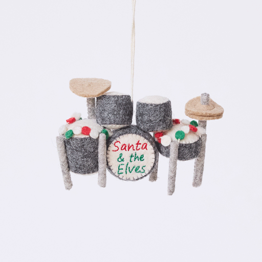 Handmade felt Christmas Drum Set Ornament from Craftspring rotating to show intricate felt details — embroidered “Santa and the Elves” band name and garland draped across the top — heirloom-quality holiday decor, ethically crafted by artisans using sustainable wool.