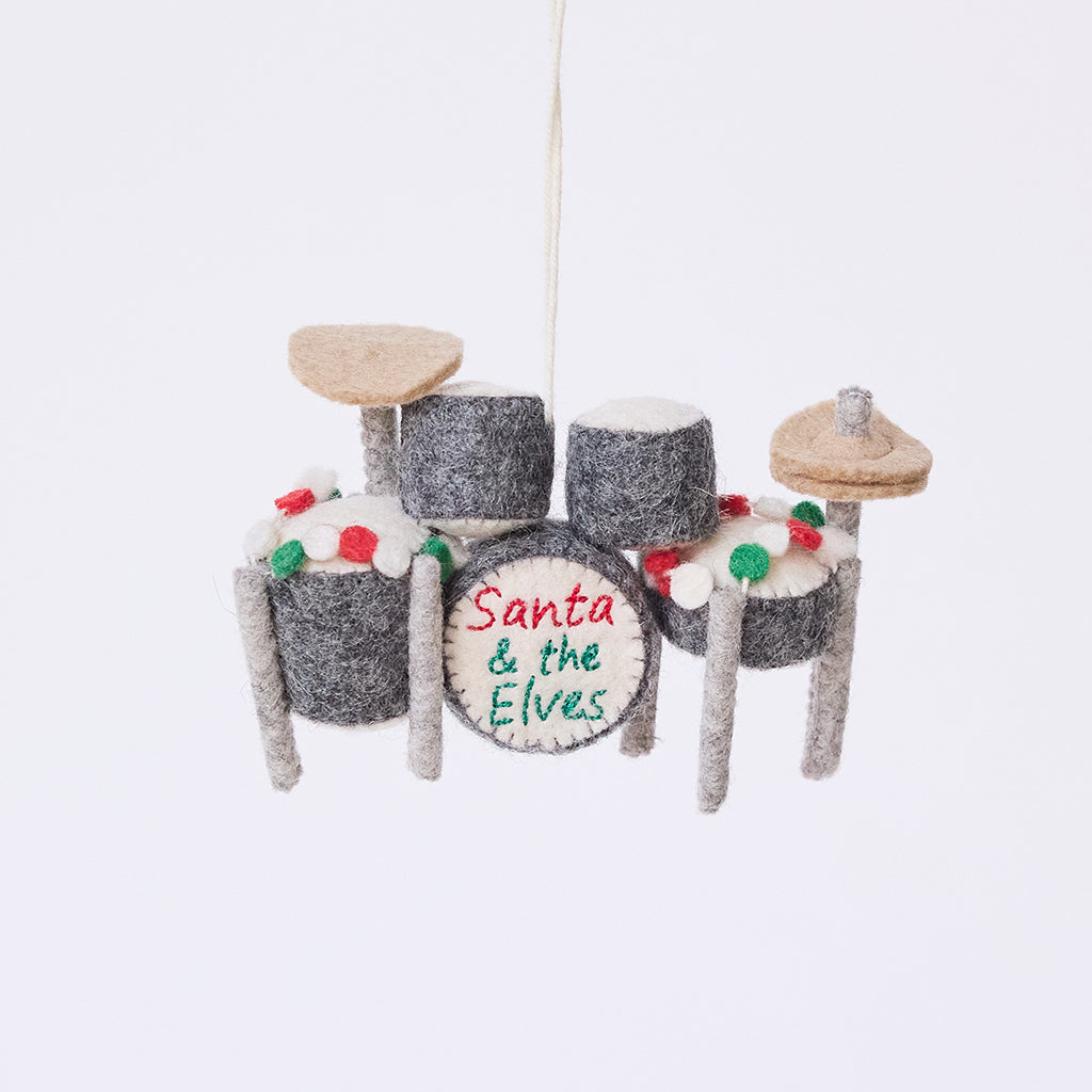 Handmade felt Christmas Drum Set Ornament from Craftspring, featuring embroidered band name “Santa and the Elves” on the center drum and a festive garland draped across the top — heirloom-quality holiday decor, intricately detailed and ethically crafted by artisans using sustainable wool.
