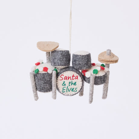 Handmade felt Christmas Drum Set Ornament from Craftspring, featuring embroidered band name “Santa and the Elves” on the center drum and a festive garland draped across the top — heirloom-quality holiday decor, intricately detailed and ethically crafted by artisans using sustainable wool.