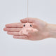 Handmade felt Dumbo Octopus ornament from Craftspring held in front of a hand to show its size—featuring charming curly pink tentacles and detailed embroidery, ethically crafted by artisans using sustainable wool.