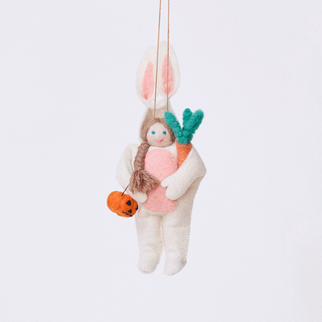 Handmade felt Easter Bunny Trick-Or-Treater ornament from Craftspring rotating to show front, side, and back views—featuring a girl in an Easter Bunny costume holding a pumpkin basket, ethically crafted by artisans using sustainable wool.