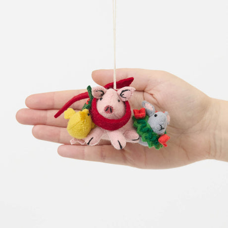 Our Festive Farm Animals Ornament brings together an adorable pink pig, a fluffy yellow chick, and a sweet gray bunny, all bundled up for the holidays. The pig wears a cozy red scarf with festive holly leaves, while the bunny sports a whimsical green holiday wreath with bright red bows. 