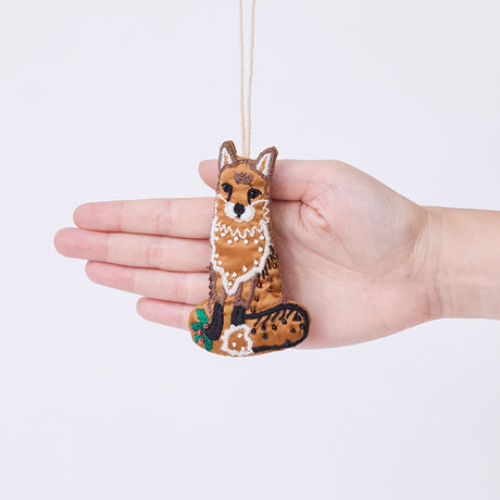 Craftspring’s Fox Beaded Ornament held in front of a hand to show its size—handmade from satin with intricate beaded and embroidered details, ethically crafted by artisans using sustainable materials.