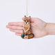 Craftspring’s Fox Beaded Ornament held in front of a hand to show its size—handmade from satin with intricate beaded and embroidered details, ethically crafted by artisans using sustainable materials.