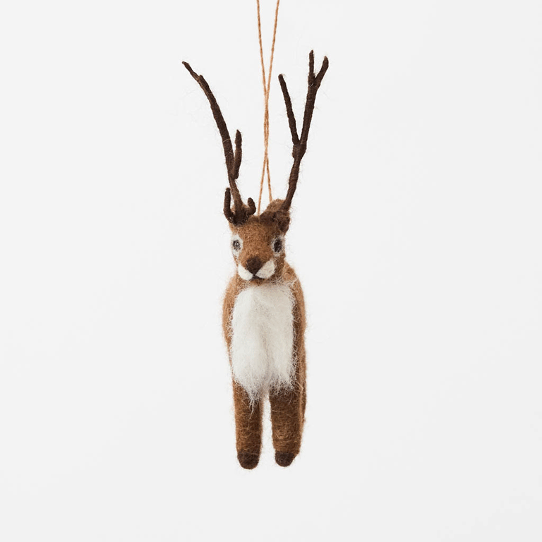 Soft, fuzzy, and full of woodland wonder, our Fuzzy Reindeer Ornament captures the quiet magic of the holiday season. With its beautiful tall antlers, sweet expression, and irresistibly fluffy coat, this darling little reindeer looks as though it has wandered straight out of an enchanted winter forest.