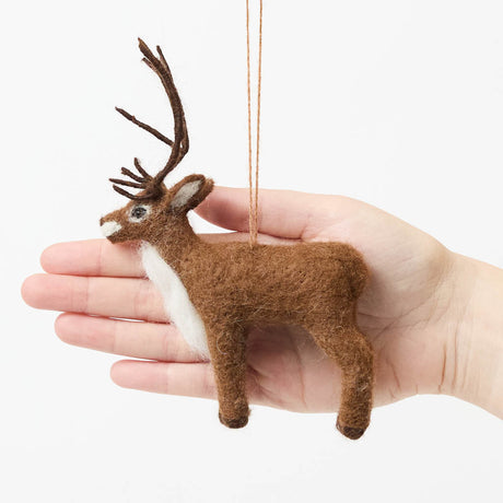 Soft, fuzzy, and full of woodland wonder, our Fuzzy Reindeer Ornament captures the quiet magic of the holiday season. With its beautiful tall antlers, sweet expression, and irresistibly fluffy coat, this darling little reindeer looks as though it has wandered straight out of an enchanted winter forest.