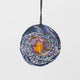 Galaxy ornament with hand-beaded Milky Way design on satin, representing stars and cosmic swirls in a spiral galaxy shape.

