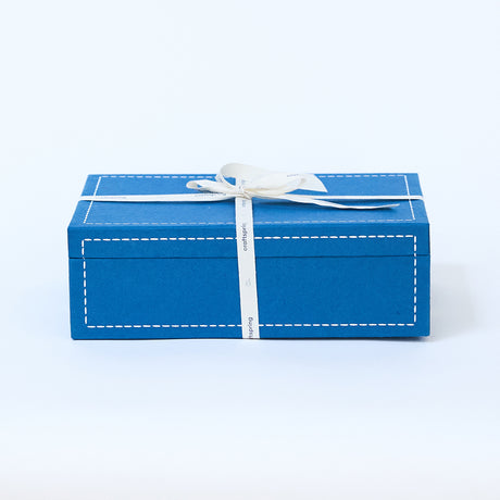 Craftspring blue gift box wrapped with a twill ribbon—high-quality holiday packaging, perfect for Christmas gifting, ethically crafted by artisans.