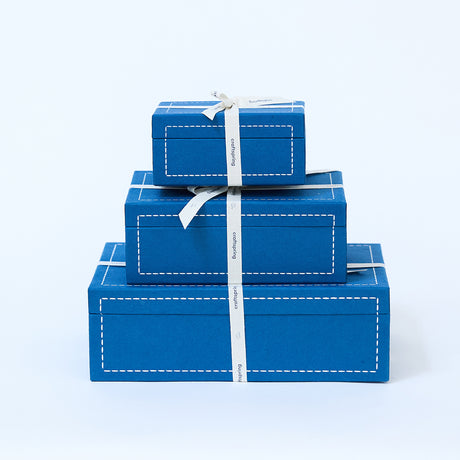 Stack of three Craftspring blue gift boxes in different sizes—elegant, artisan-made packaging for thoughtful holiday gifting.