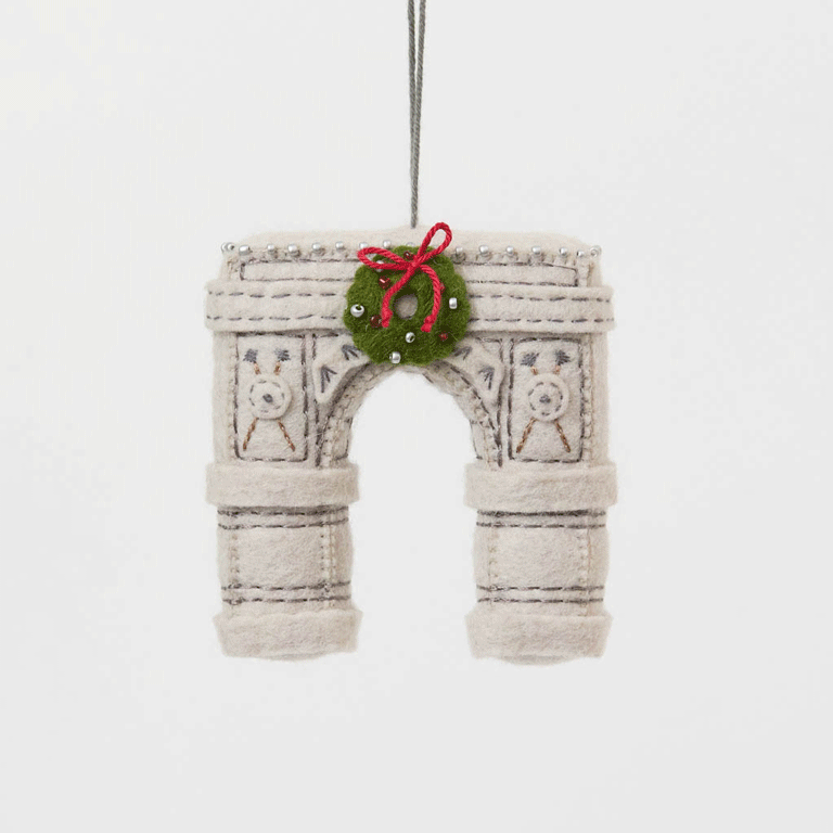  Our Grand Arch Ornament captures that timeless landmark, beautifully adorned with a festive holiday wreath for an extra touch of seasonal cheer.

Carefully handcrafted with embroidered architectural details, sculptural felt columns, delicate bead accents, and a miniature wreath tied with a bright red bow, this ornament celebrates both the elegance of the famous arch and the magic of Christmas in New York. 