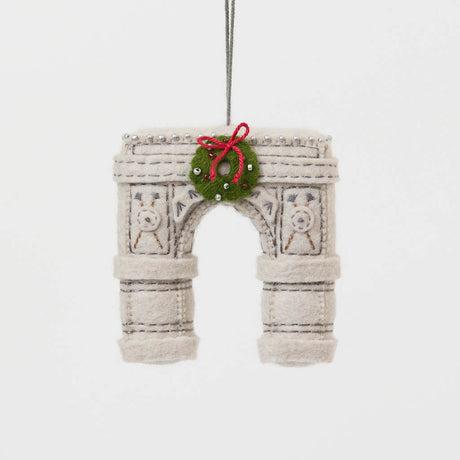  Our Grand Arch Ornament captures that timeless landmark, beautifully adorned with a festive holiday wreath for an extra touch of seasonal cheer.

Carefully handcrafted with embroidered architectural details, sculptural felt columns, delicate bead accents, and a miniature wreath tied with a bright red bow, this ornament celebrates both the elegance of the famous arch and the magic of Christmas in New York. 