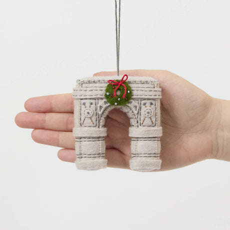  Our Grand Arch Ornament captures that timeless landmark, beautifully adorned with a festive holiday wreath for an extra touch of seasonal cheer.

Carefully handcrafted with embroidered architectural details, sculptural felt columns, delicate bead accents, and a miniature wreath tied with a bright red bow, this ornament celebrates both the elegance of the famous arch and the magic of Christmas in New York. 