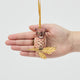 A vintage-inspired Great Horned Owl Resin Ornament, hand-painted in the Philippines and perched on a golden metal oak branch with sculpted leaves.