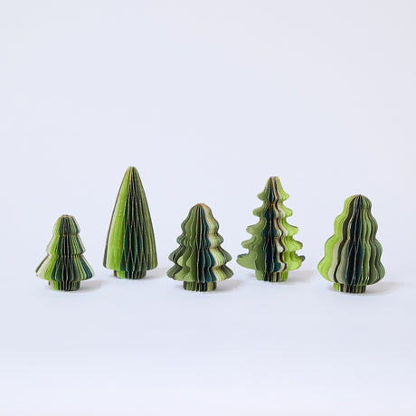 Craftspring’s Green Honeycomb Paper Mini Trees — Set of 5, standing upright with several shades of green and gold sparkle on the edges, each tree a different shape — handmade by artisans from recycled cotton waste, perfect for mantles or Christmas scenes.