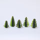 Craftspring’s Green Honeycomb Paper Mini Trees — Set of 5, standing upright with several shades of green and gold sparkle on the edges, each tree a different shape — handmade by artisans from recycled cotton waste, perfect for mantles or Christmas scenes.