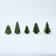 Craftspring’s Green Honeycomb Paper Mini Trees — Set of 5, standing upright with several shades of green and gold sparkle on the edges, each tree a different shape — handmade by artisans from recycled cotton waste, perfect for mantles or Christmas scenes.