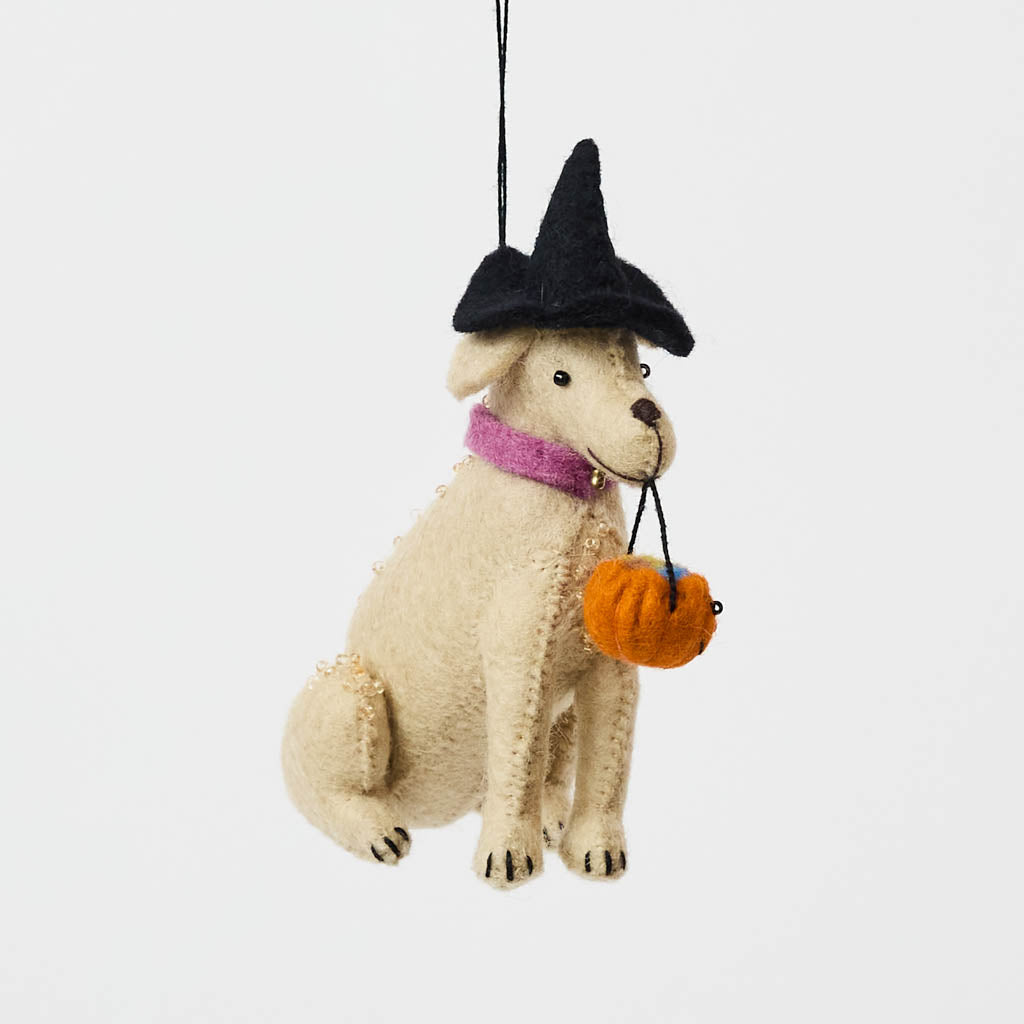 A handmade felt Halloween Lab Ornament featuring a Labrador retriever dressed in a witch hat and carrying a tiny jack-o’-lantern trick-or-treat bucket.