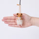 Craftspring’s Hamster ornament held in hand to show its size—needle-felted with whiskers and sweet little paws, ethically crafted by artisans using sustainable wool.