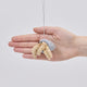 Handmade felt Hermit Crab ornament from Craftspring held in front of a hand to show its size—featuring intricate beaded and embroidered details on the shell and legs, ethically crafted by artisans using sustainable wool.
