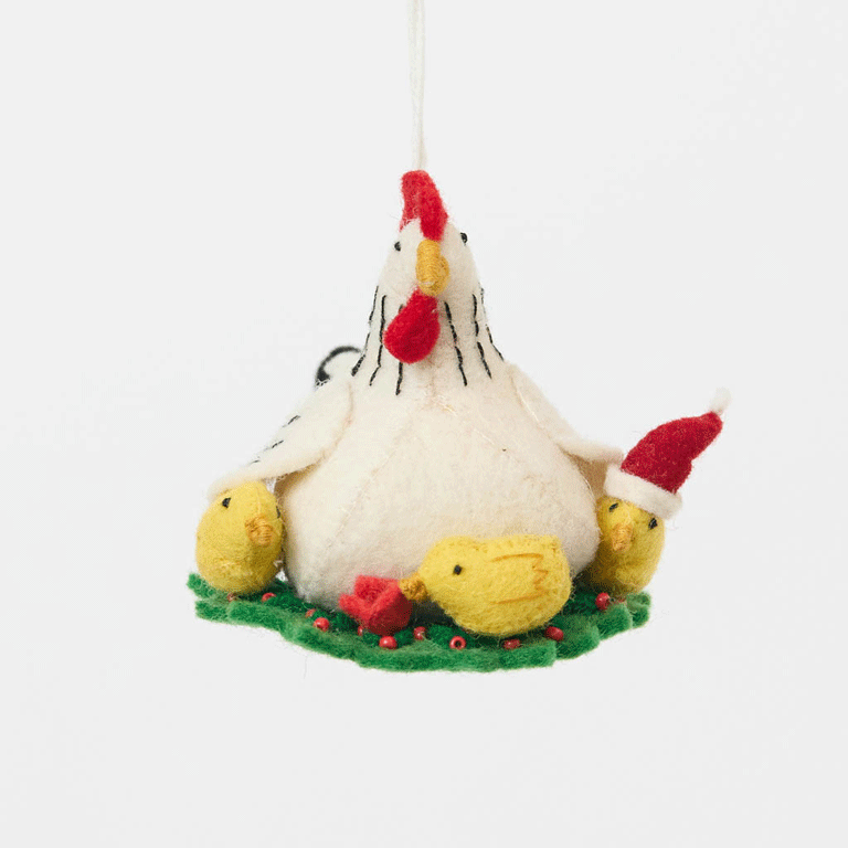 Gathered together on a festive green wreath our Holiday Hen with Chicks Ornament is a sweet celebration of family, nurturing, and holiday togetherness. A proud mother hen watches over her fluffy yellow chicks, while one festive little chick sports a tiny red Santa hat, adding an extra dash of Christmas cheer. 
