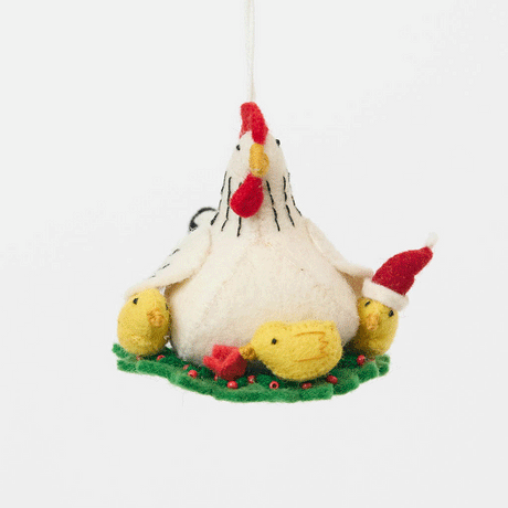 Gathered together on a festive green wreath our Holiday Hen with Chicks Ornament is a sweet celebration of family, nurturing, and holiday togetherness. A proud mother hen watches over her fluffy yellow chicks, while one festive little chick sports a tiny red Santa hat, adding an extra dash of Christmas cheer. 