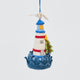 Handmade felt Holiday Lighthouse Christmas ornament from Craftspring, featuring a seagull on top, crashing waves, and a Christmas tree—adorned with intricate beaded and embroidered details, heirloom-quality holiday decor, ethically crafted by artisans using sustainable wool.