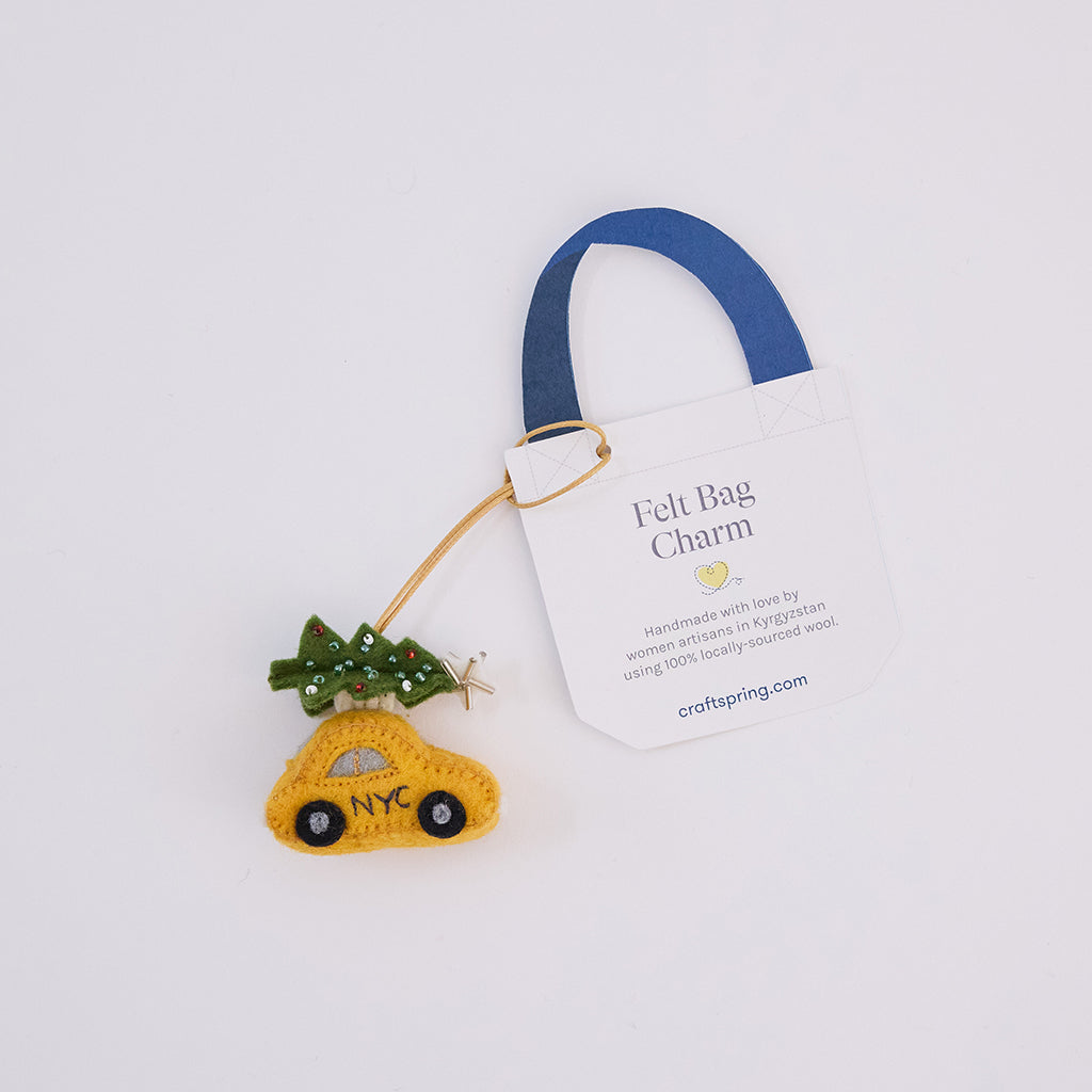 Craftspring’s Holiday Taxi Bag Charm — handmade felt taxi with a beautifully beaded Christmas tree on top, crafted by women artisans in Kyrgyzstan using locally sourced wool — heirloom-quality holiday accessory, perfect for Christmas gifting, ethically crafted by artisans using sustainable wool.