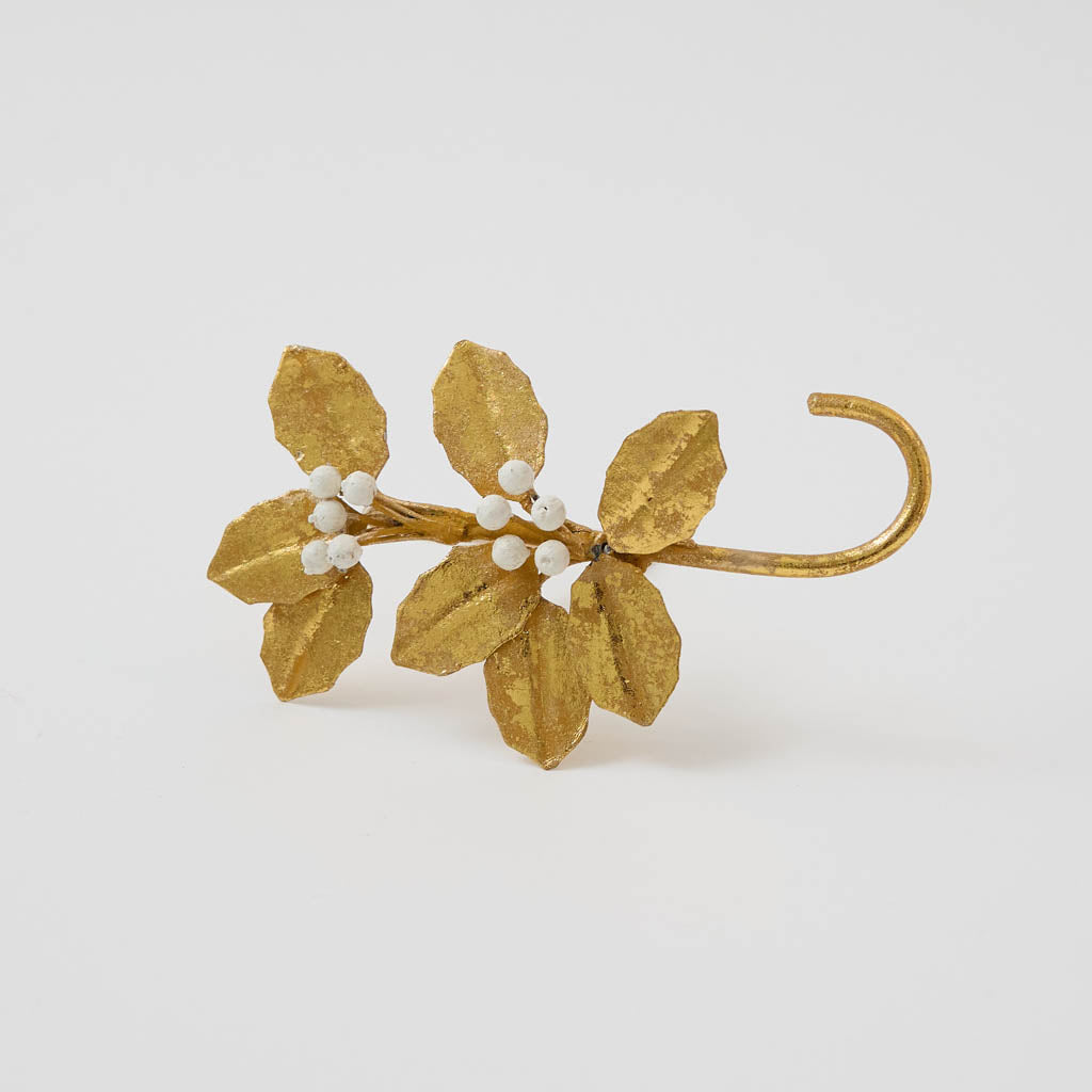 Deck the mantel! Our Holly Metal Stocking Holder turns a holiday essential into a little piece of botanical beauty, with golden holly leaves and clusters of snowy white berries handcrafted in metal.