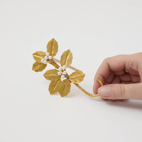 Deck the mantel! Our Holly Metal Stocking Holder turns a holiday essential into a little piece of botanical beauty, with golden holly leaves and clusters of snowy white berries handcrafted in metal.
