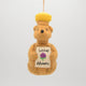 Festive hand-felted wool ornament of a honey bear jar, sparkling with beaded details and a stitched clover on its chest. Inspired by Winnie the Pooh, this cozy golden bear makes a charming holiday gift and nostalgic keepsake. Includes a hanging string and measures approximately 4.5 inches tall — perfect for tree decorating, gift-topping, or stocking stuffing.