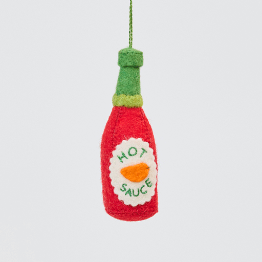 Craftspring’s handmade felt Hot Sauce ornament twirling to show its embroidered and applique details—playful holiday decor for spice lovers, sustainably crafted by artisans using wool.