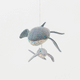 Graceful, gentle, and full of wonder, our Humpback Whale with Baby Ornament captures one of nature’s most touching sights—a mother whale guiding her calf through the open sea. Handcrafted from soft felted wool and accented with shimmering blue beadwork, this beautiful ornament celebrates the deep connection between parent and child while honoring the majestic marine life that frequents Maine’s coastal waters.