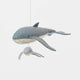 Graceful, gentle, and full of wonder, our Humpback Whale with Baby Ornament captures one of nature’s most touching sights—a mother whale guiding her calf through the open sea. Handcrafted from soft felted wool and accented with shimmering blue beadwork, this beautiful ornament celebrates the deep connection between parent and child while honoring the majestic marine life that frequents Maine’s coastal waters.
