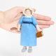 Handcrafted felt ornament of Jane Austen, featuring the beloved author standing with a feather quill in one hand and a felt copy of Pride and Prejudice in the other. She wears a period-style dress and bonnet, all made from natural merino-blend wool with fine stitched details. Includes a string for hanging and measures approximately 6 inches tall. Hand for scale reference.