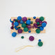 Handmade felt Jewel Tone Ball Garland from Craftspring, featuring deep jewel-tone felt balls strung on a gold ribbon—heirloom-quality holiday decor perfect for adding rich, festive color, ethically crafted by artisans using sustainable wool.