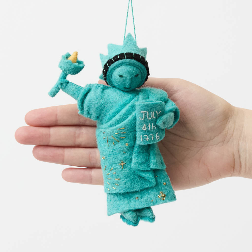 Celebrate American independence with this handcrafted July 4th Lady Liberty Ornament. Inspired by the Statue of Liberty and the founding of the United States, it's perfect for Christmas trees, Fourth of July celebrations, and Americana holiday décor.