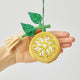 Sunny yellow lemon ornament with beaded embellishments and tassel, perfect for fresh and festive gift presentation.
