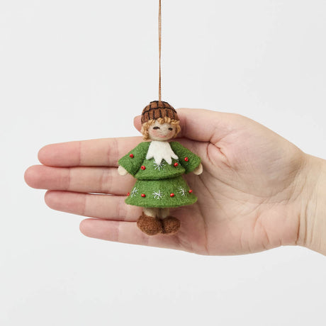 Inspired by the gentle wonder of Waldorf traditions, our Little Acorn Kid Ornament captures the whimsical spirit of a woodland fairy tale. Wearing an adorable felted acorn cap and a charming oak-leaf skirt.
