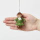Inspired by the gentle wonder of Waldorf traditions, our Little Acorn Kid Ornament captures the whimsical spirit of a woodland fairy tale. Wearing an adorable felted acorn cap and a charming oak-leaf skirt.