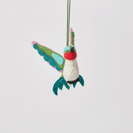 Craftspring’s Little Migrator Hummingbird Ornament from the Iconic Craftspring Ornaments Bundle rotating to show front, side, and back views — felt hummingbird with embroidered and beaded details, a whimsical ornament perfect for holiday gifting — heirloom-quality Christmas decor, ethically crafted by artisans using sustainable wool.