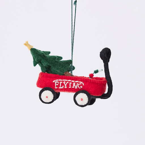 Craftspring’s Little Red Wagon with Tree Ornament rotating to show front, side, and back views — felt little red wagon carrying a Christmas tree and garland, with embroidered and beaded details, a playful ornament perfect for holiday gifting — heirloom-quality Christmas decor, ethically crafted by artisans using sustainable wool.
