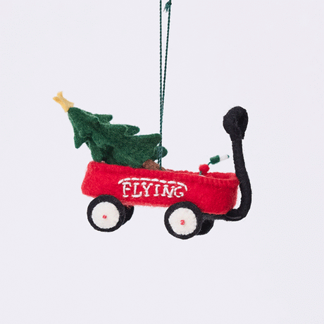 Craftspring’s Little Red Wagon with Tree Ornament rotating to show front, side, and back views — felt little red wagon carrying a Christmas tree and garland, with embroidered and beaded details, a playful ornament perfect for holiday gifting — heirloom-quality Christmas decor, ethically crafted by artisans using sustainable wool.