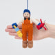 Craftspring’s Maine Lobsterman felt Christmas ornament held in front of a hand to show its size—charming nautical holiday decor, handmade by artisans in India with sustainable wool.
