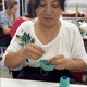 GIF of the sewing of a felt blueberry pint ornament with hand-felted blue berries in a soft green wool basket. Handmade from natural wool felt using traditional needle-felting. Fair trade and ready to hang.