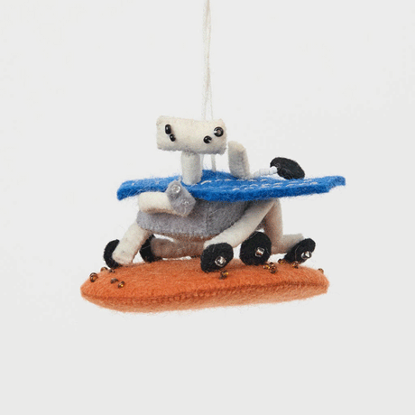 Explore the Red Planet with our handcrafted Mars Opportunity Rover Ornament, inspired by NASA’s legendary Mars Exploration Rover, affectionately known as "Oppy." Designed in soft wool felt with intricate handcrafted details, this ornament captures the iconic rover as it traverses the dusty Martian landscape in search of scientific discoveries.