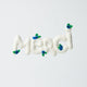 Merci Gift Box Set featuring a felt blueberry ornament, white daisy flower bouquet in vase, and daisy greeting card. Handmade from wool felt with French-inspired floral charm. Fair trade and ready to gift.