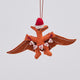 Handmade felt Merry Pterodactyl ornament from Craftspring, featuring embroidered details, a red Santa hat, and holding a festive “MERRY” garland—showcasing artisan craftsmanship and playful holiday charm, ethically crafted using sustainable wool.