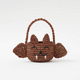 A hand-crocheted raffia Mini Bat Basket featuring playful wings, pointed ears, tiny fangs, and a sweet embroidered face for Halloween treats, treasures, and imaginative play.