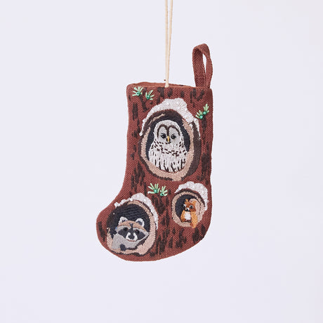 Handmade linen Woodland Mini Stocking ornament from Craftspring, featuring intricate beaded and embroidered details with animals peeking out of holes in a tree, including an owl, raccoon, and squirrel—heirloom-quality Christmas decor, ethically crafted by artisans using sustainable materials.